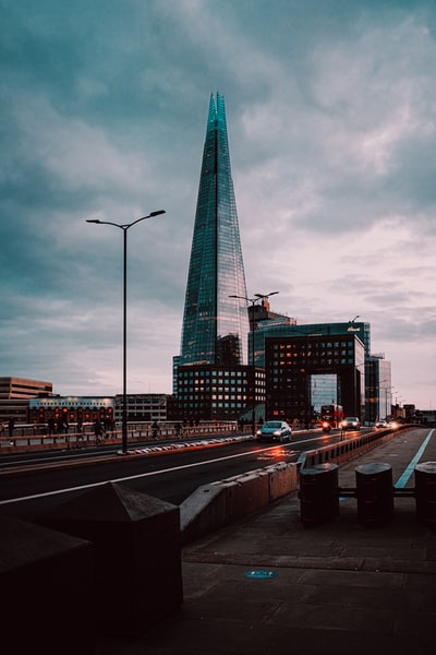 High-rise building near the cars on the road during the day
